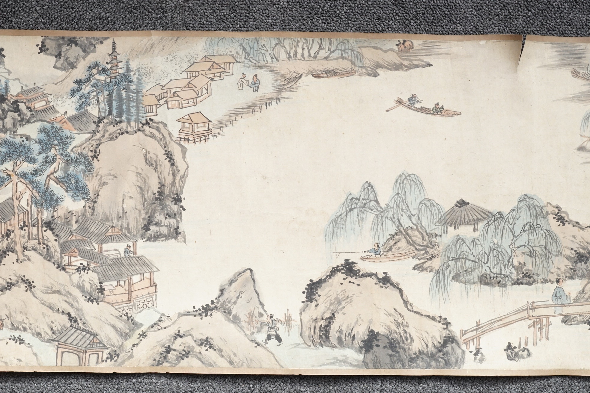 Chinese School , (Qing dynasty), Figures in a mountainous river landscape, Ink and colour on paper handscroll, 268.5cm x 29cm excluding borders